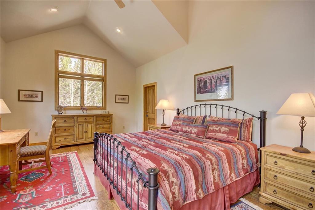 265 Mountain Bluebell Road Keystone, CO 80435 - Photo 15 of 35 a bedroom with a bed and wooden floor