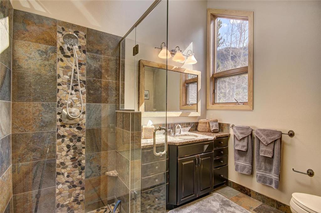 265 Mountain Bluebell Road Keystone, CO 80435 - Photo 19 of 35 a bathroom with a sink a toilet and shower