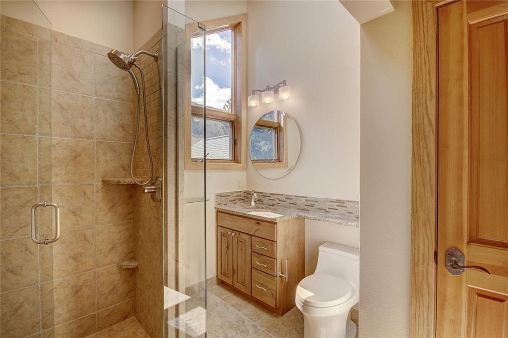 265 Mountain Bluebell Road Keystone, CO 80435 - Photo 22 of 35 a bathroom with a granite countertop sink toilet and shower