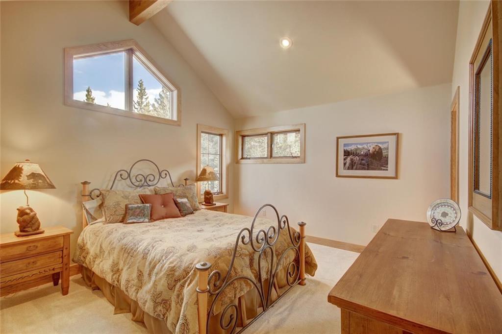 265 Mountain Bluebell Road Keystone, CO 80435 - Photo 23 of 35 a bedroom with beds and a night stand