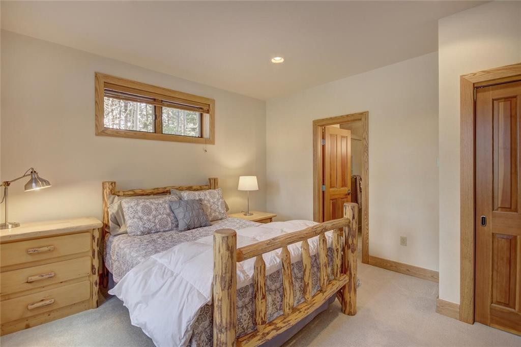 265 Mountain Bluebell Road Keystone, CO 80435 - Photo 24 of 35 a bedroom with a bed and a night stand