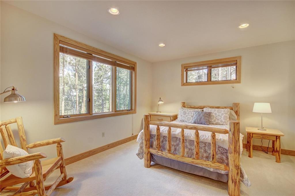 265 Mountain Bluebell Road Keystone, CO 80435 - Photo 25 of 35 a bedroom with a bed and a night stand