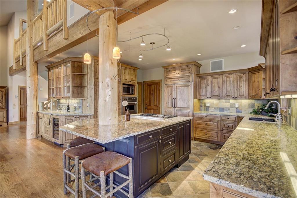 265 Mountain Bluebell Road Keystone, CO 80435 - Photo 29 of 35 a large kitchen with stainless steel appliances granite countertop a large counter top a stove a sink and a refrigerator