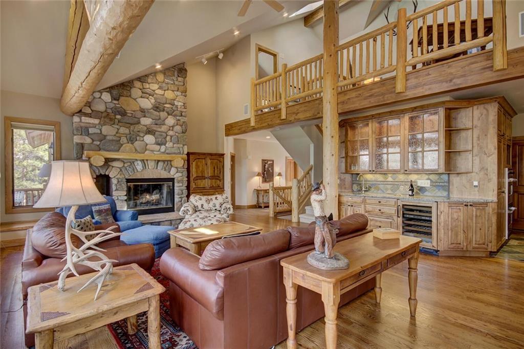 265 Mountain Bluebell Road Keystone, CO 80435 - Photo 4 of 35 a living room with furniture a fireplace and a floor to ceiling window
