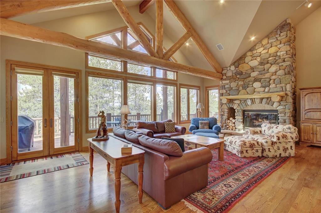 265 Mountain Bluebell Road Keystone, CO 80435 - Photo 33 of 35 a living room with furniture large windows and a fireplace
