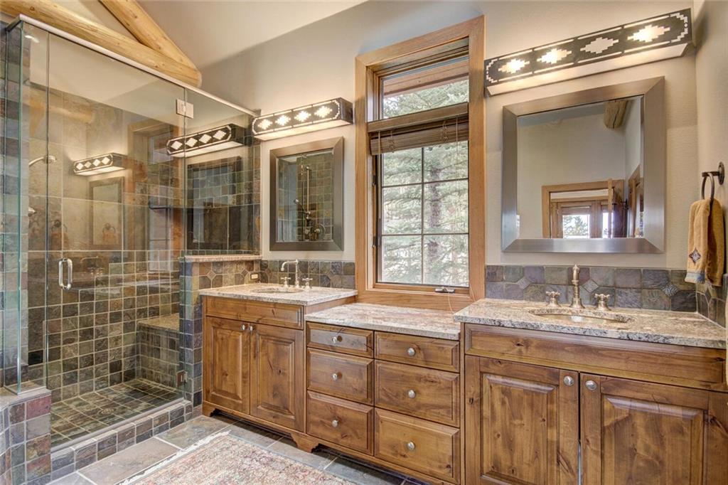 265 Mountain Bluebell Road Keystone, CO 80435 - Photo 6 of 35 a bathroom with a double vanity sink mirror and shower