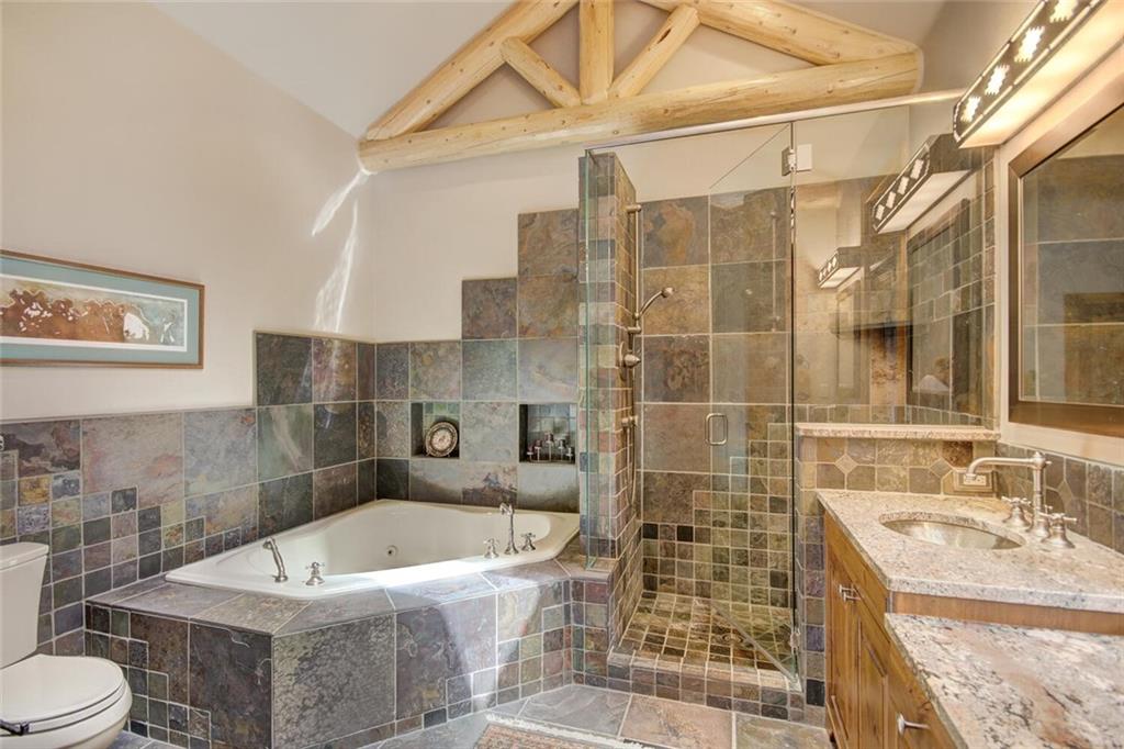 265 Mountain Bluebell Road Keystone, CO 80435 - Photo 7 of 35 a bathroom with a granite countertop sink a toilet and shower