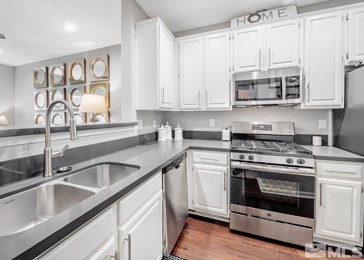 900 South Meadows Parkway, Unit 4123 Reno, NV 89521 - Photo 5 of 19 a kitchen with stainless steel appliances granite countertop a sink and a stove