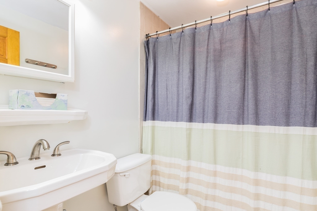 4 Acadia Kimball Road, Unit 4 Amesbury, MA 01913 - Photo 14 of 20 a bathroom with a sink a toilet and shower curtain