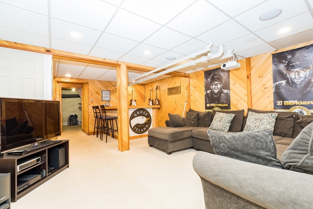 4 Acadia Kimball Road, Unit 4 Amesbury, MA 01913 - Photo 15 of 20 a living room with furniture and a flat screen tv