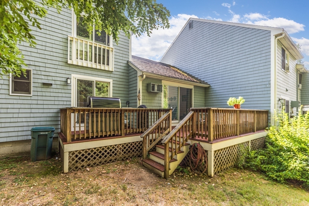 4 Acadia Kimball Road, Unit 4 Amesbury, MA 01913 - Photo 9 of 20 a view of a deck with a bench and wooden fence