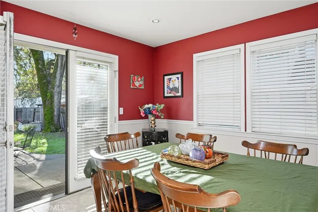 a dining room with furniture and a window
