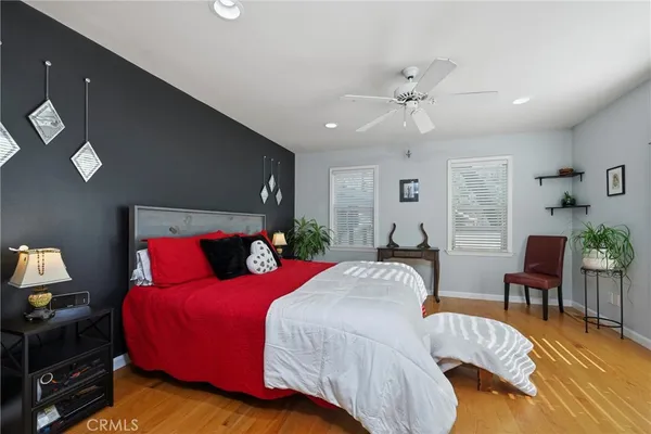 a bedroom with a bed and wooden floor