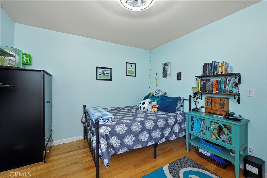 21264 Santa Clara Road Middletown, CA 95461 - Photo 29 of 39 a bedroom with a bed and wooden floor