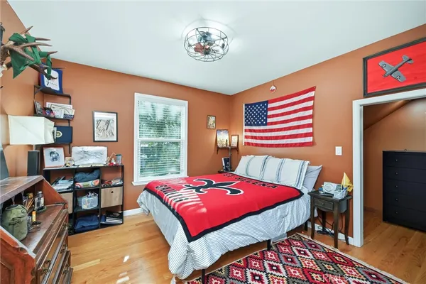 a bedroom with a bed and wooden floor