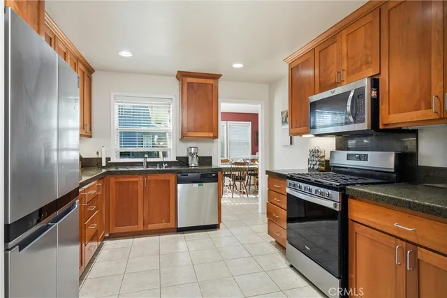 a kitchen with stainless steel appliances granite countertop a stove sink and cabinets