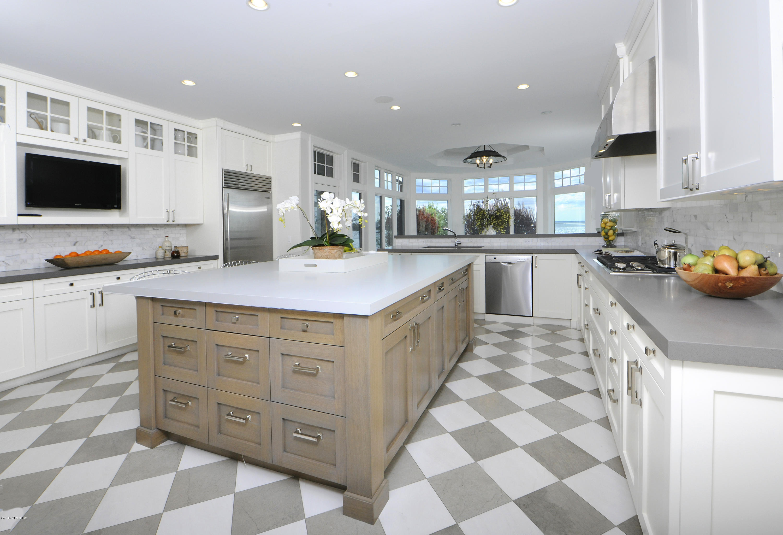 215 Byram Shore Road Greenwich, CT 06830 - Photo 11 of 26 a kitchen with stainless steel appliances granite countertop a sink and a stove