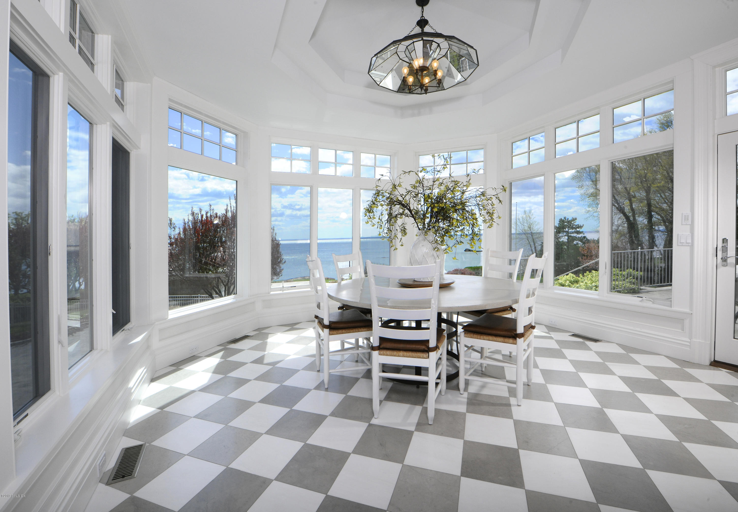 215 Byram Shore Road Greenwich, CT 06830 - Photo 12 of 26 a view of a dining room with a table and chairs