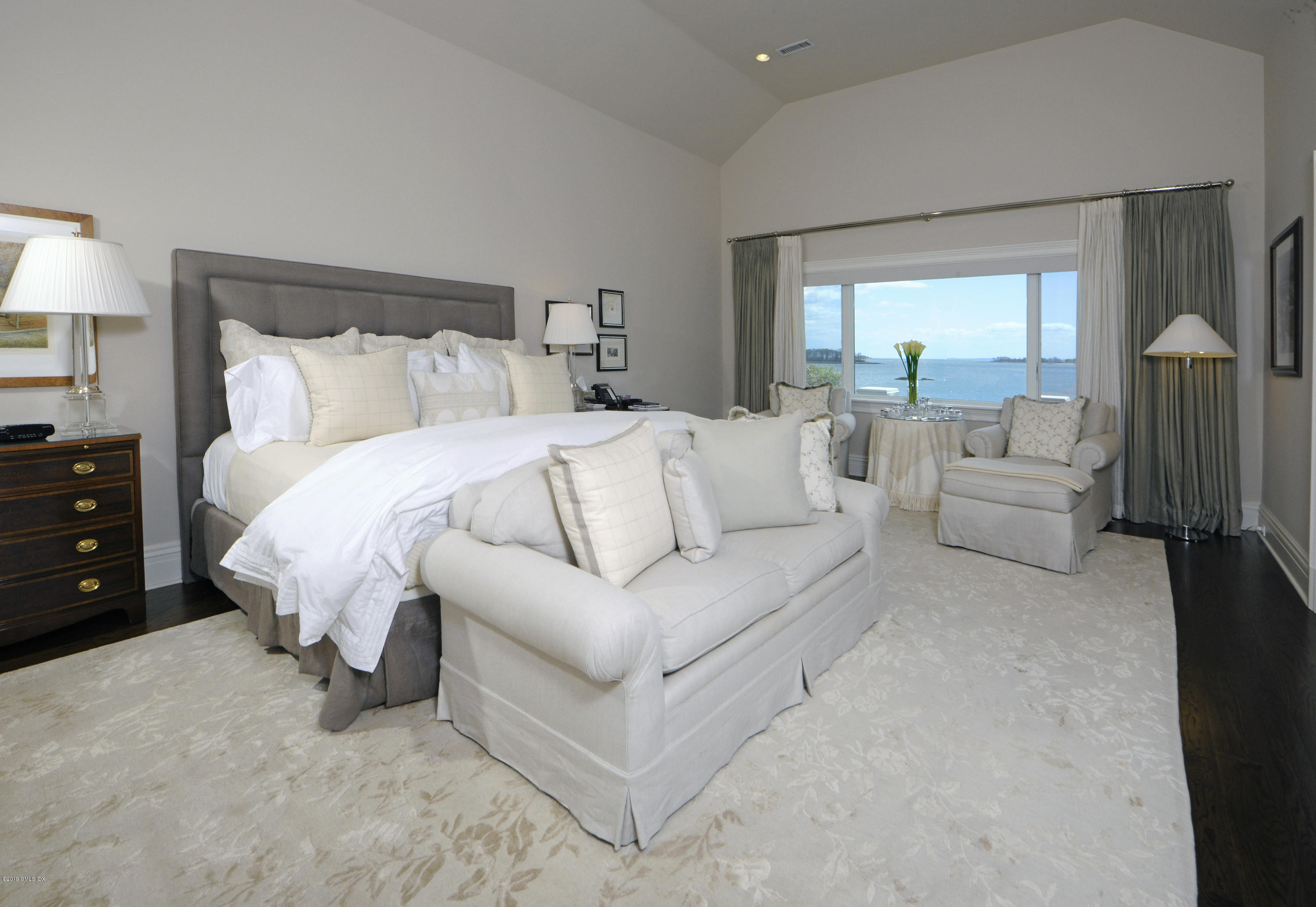 215 Byram Shore Road Greenwich, CT 06830 - Photo 13 of 26 a bed room with a bed and a couch