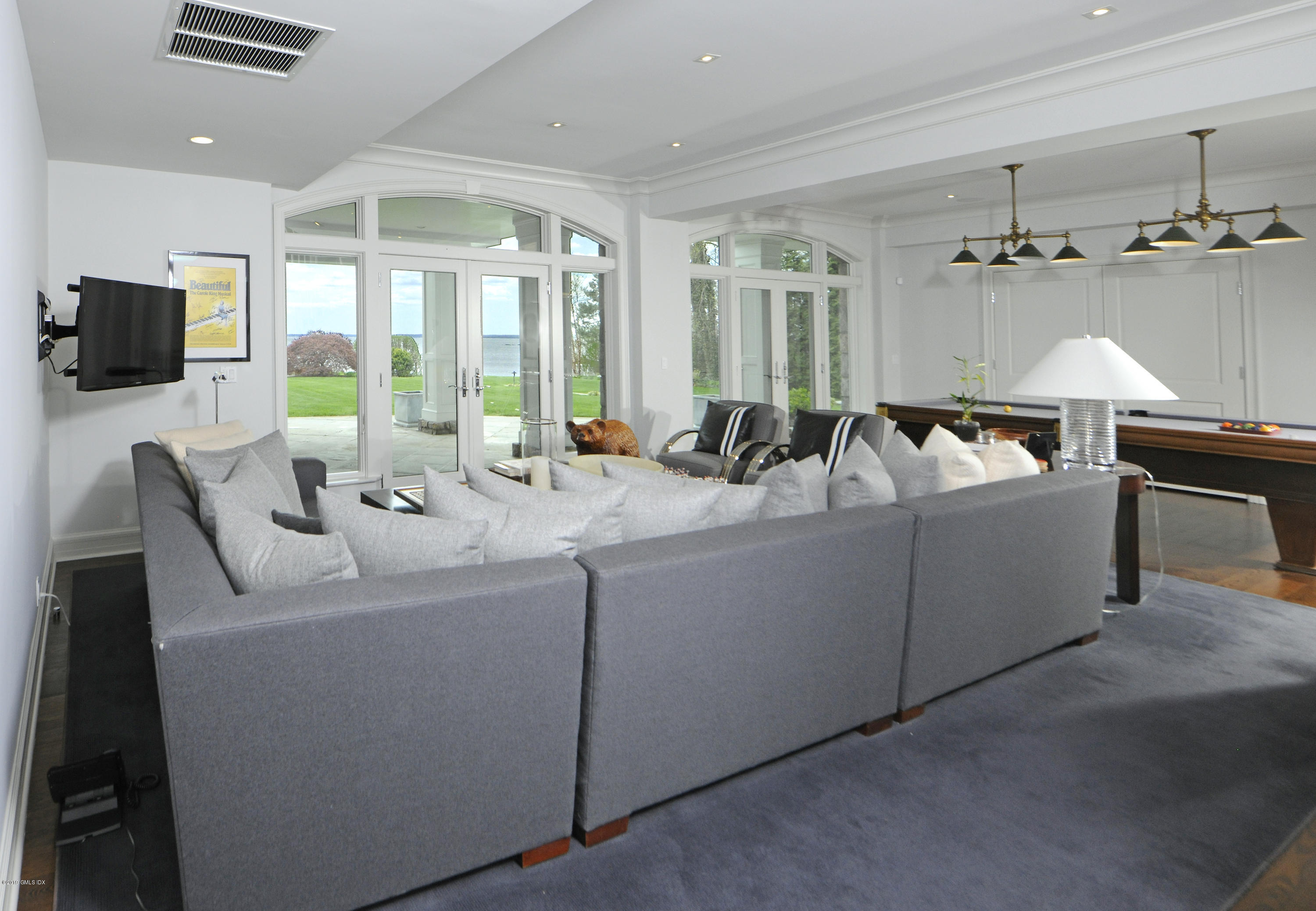 215 Byram Shore Road Greenwich, CT 06830 - Photo 16 of 26 a living room with furniture and a flat screen tv