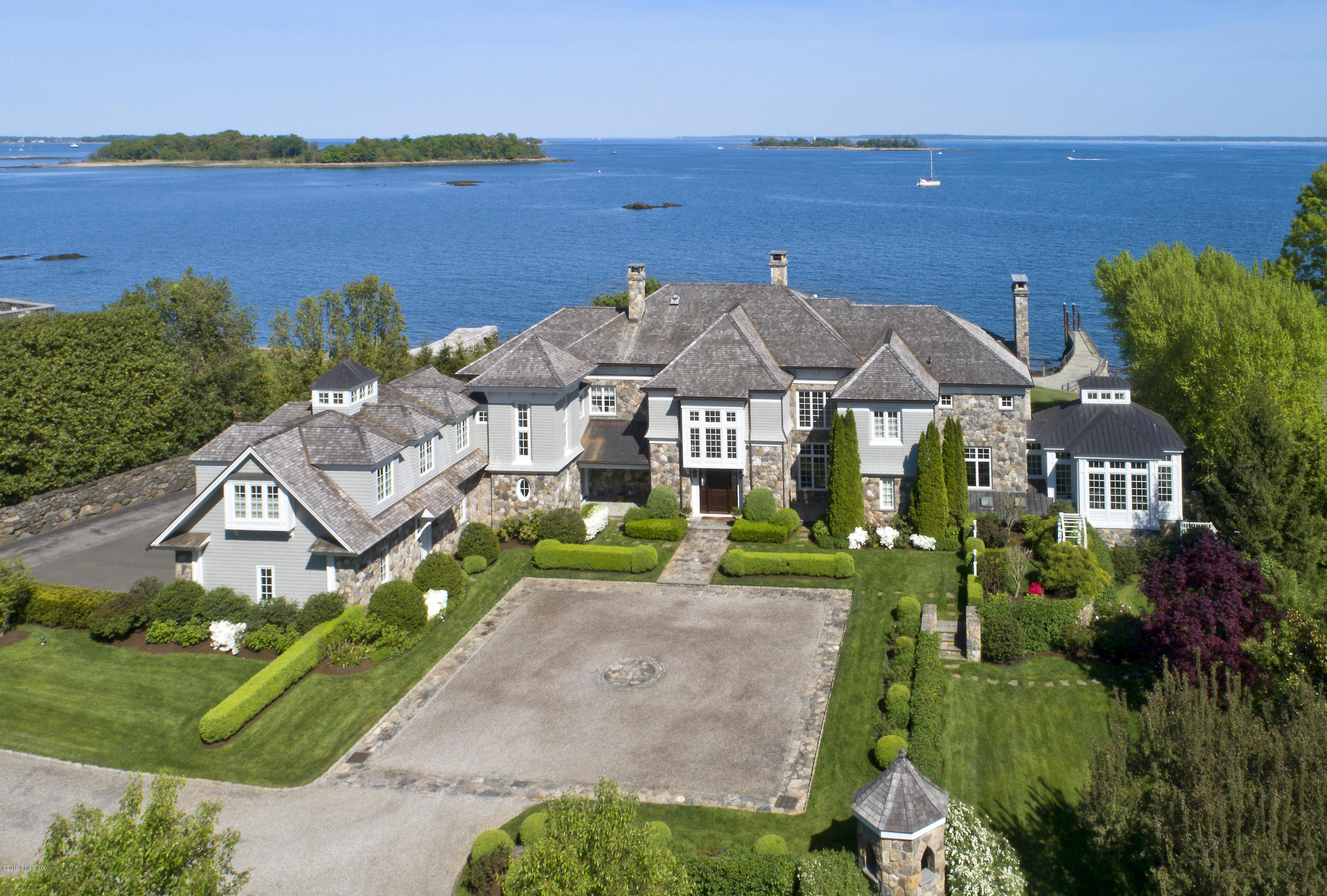 215 Byram Shore Road Greenwich, CT 06830 - Photo 2 of 26 a view of a house with a yard and potted plants