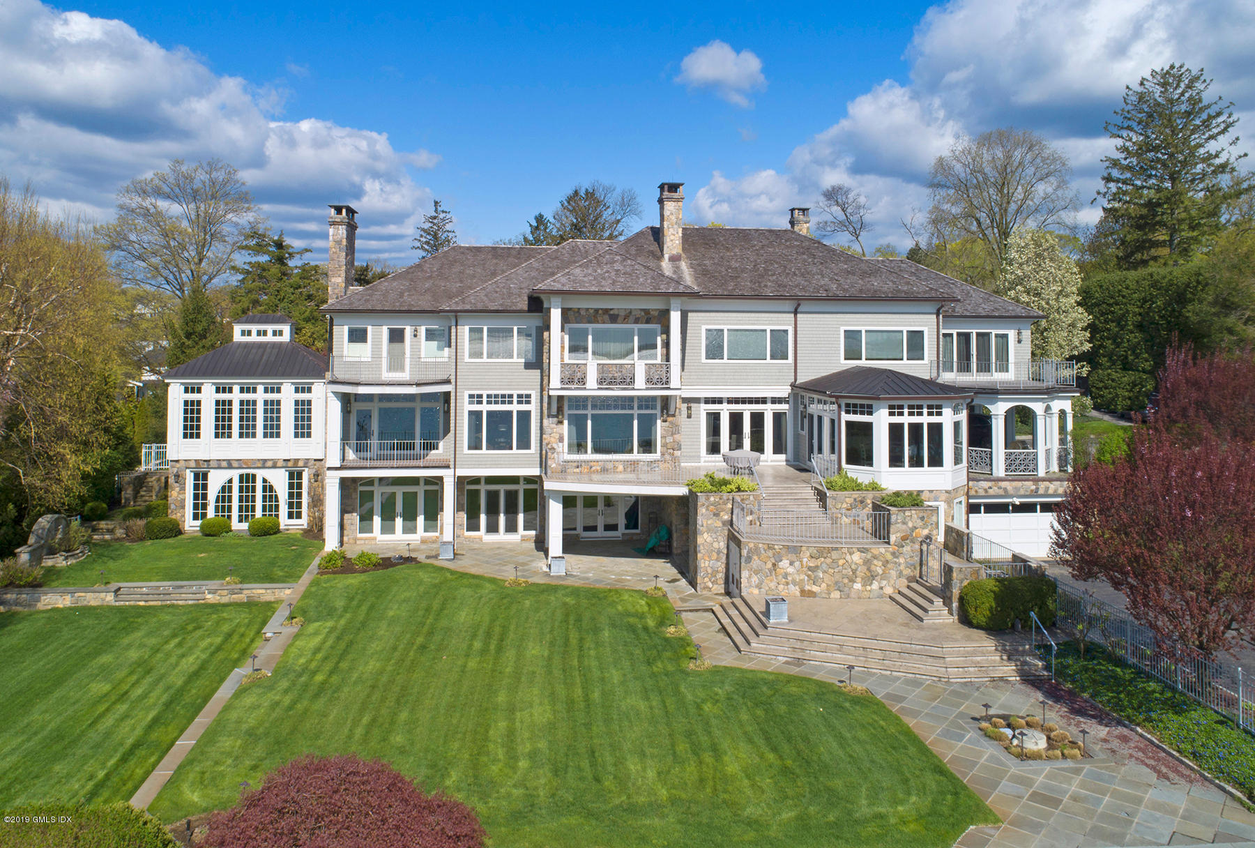 215 Byram Shore Road Greenwich, CT 06830 - Photo 22 of 26 a front view of a house with a garden
