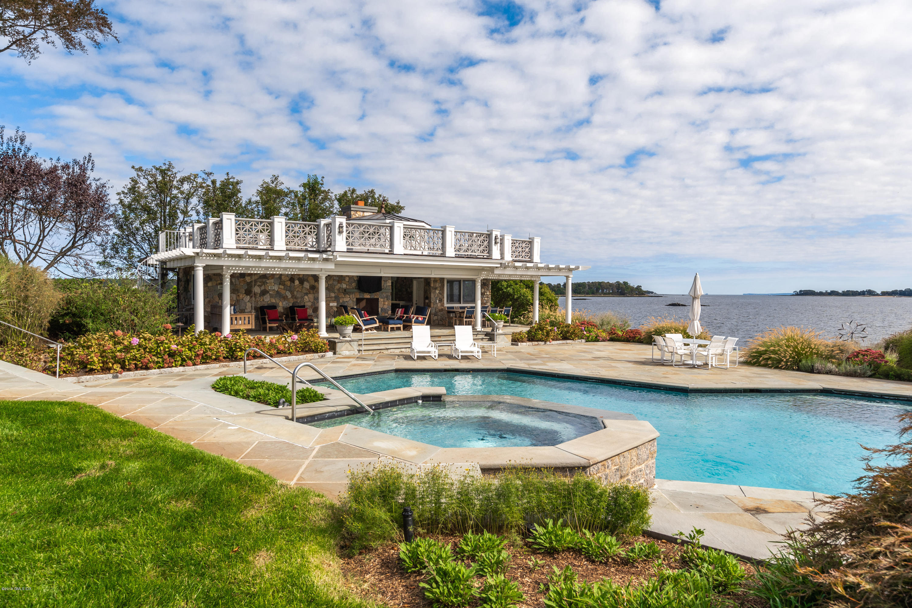 215 Byram Shore Road Greenwich, CT 06830 - Photo 24 of 26 a view of a house with swimming pool and sitting area