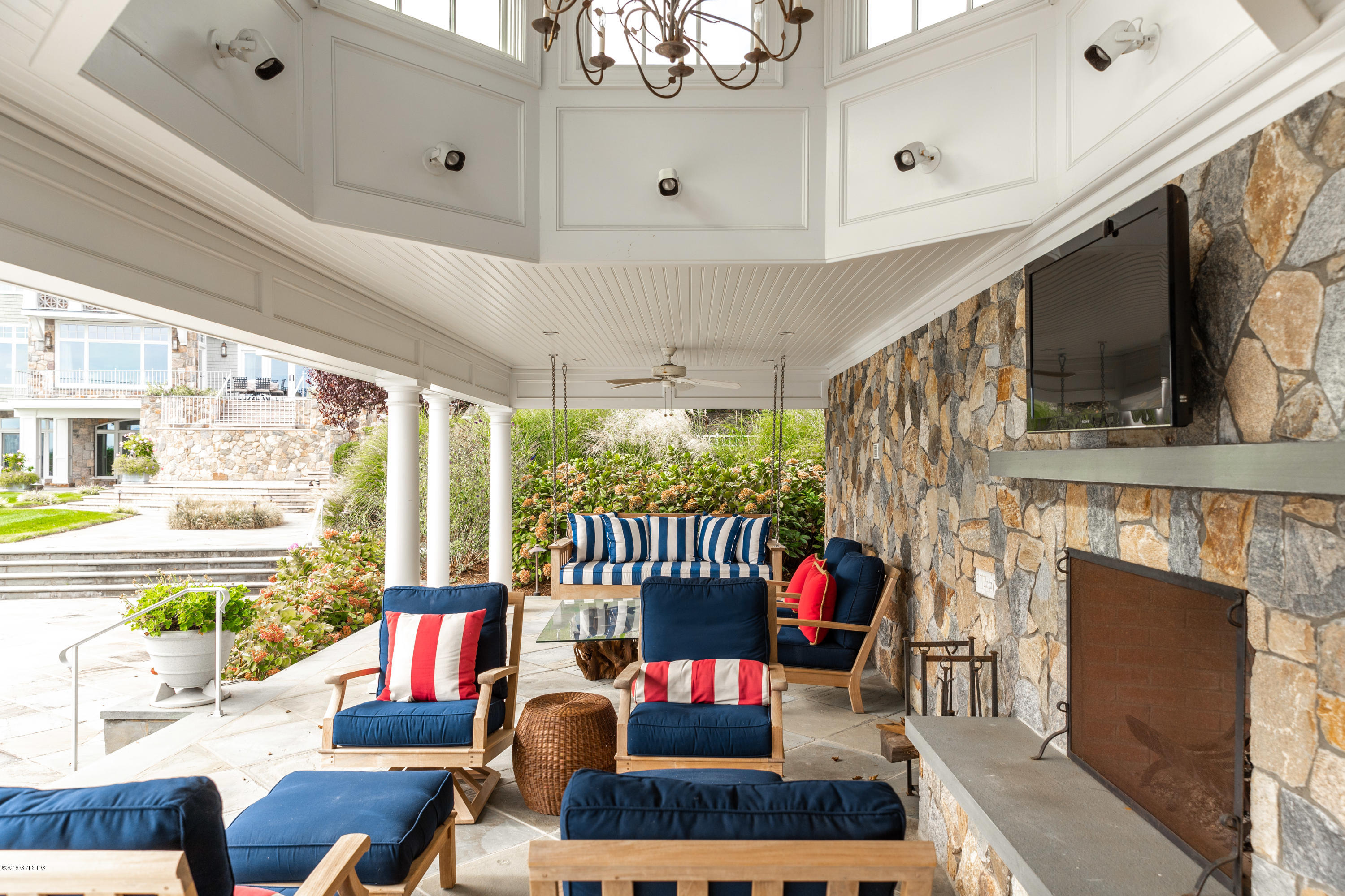 215 Byram Shore Road Greenwich, CT 06830 - Photo 25 of 26 a living room with furniture a fireplace and a flat screen tv