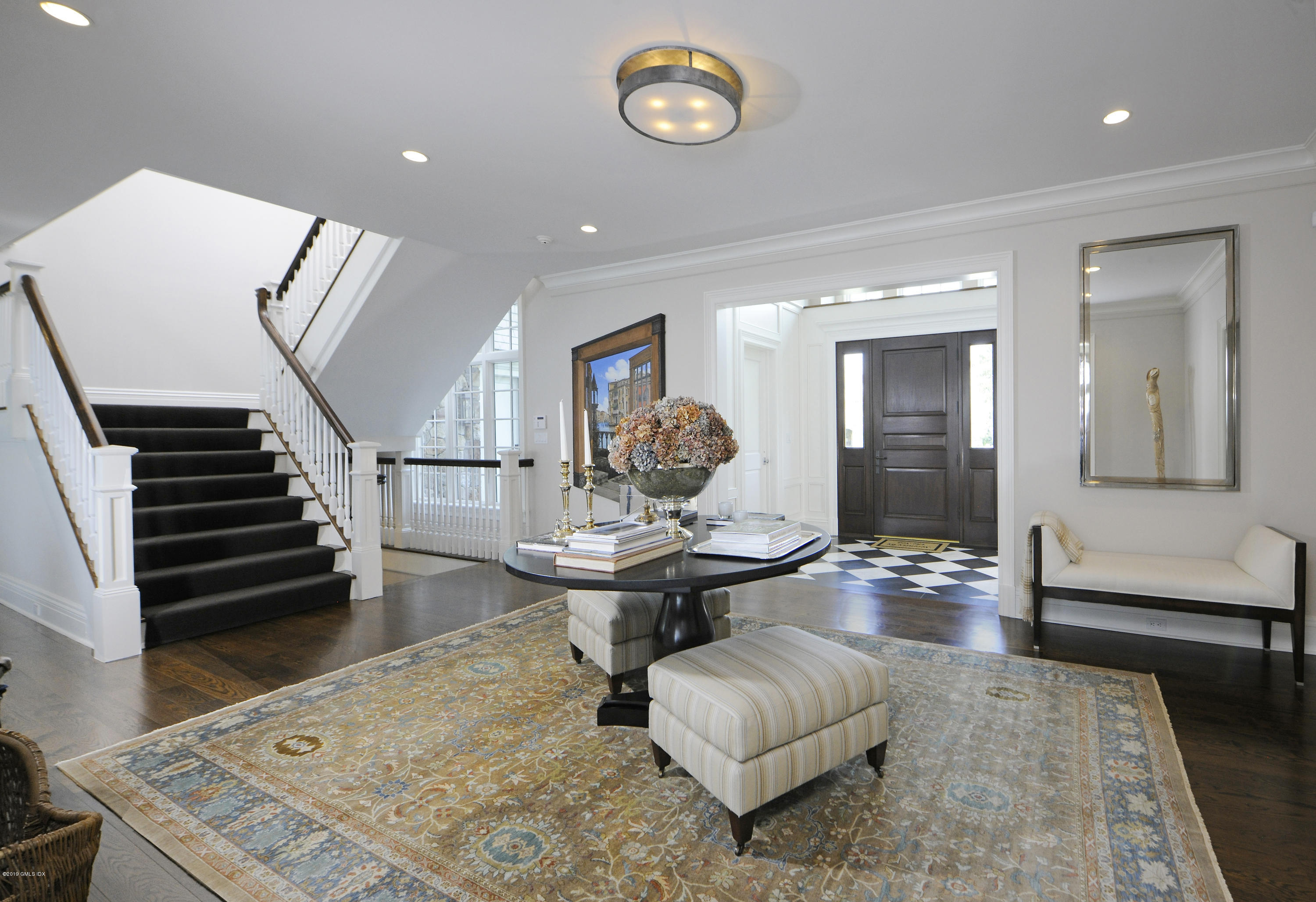215 Byram Shore Road Greenwich, CT 06830 - Photo 3 of 26 a living room with furniture and a table