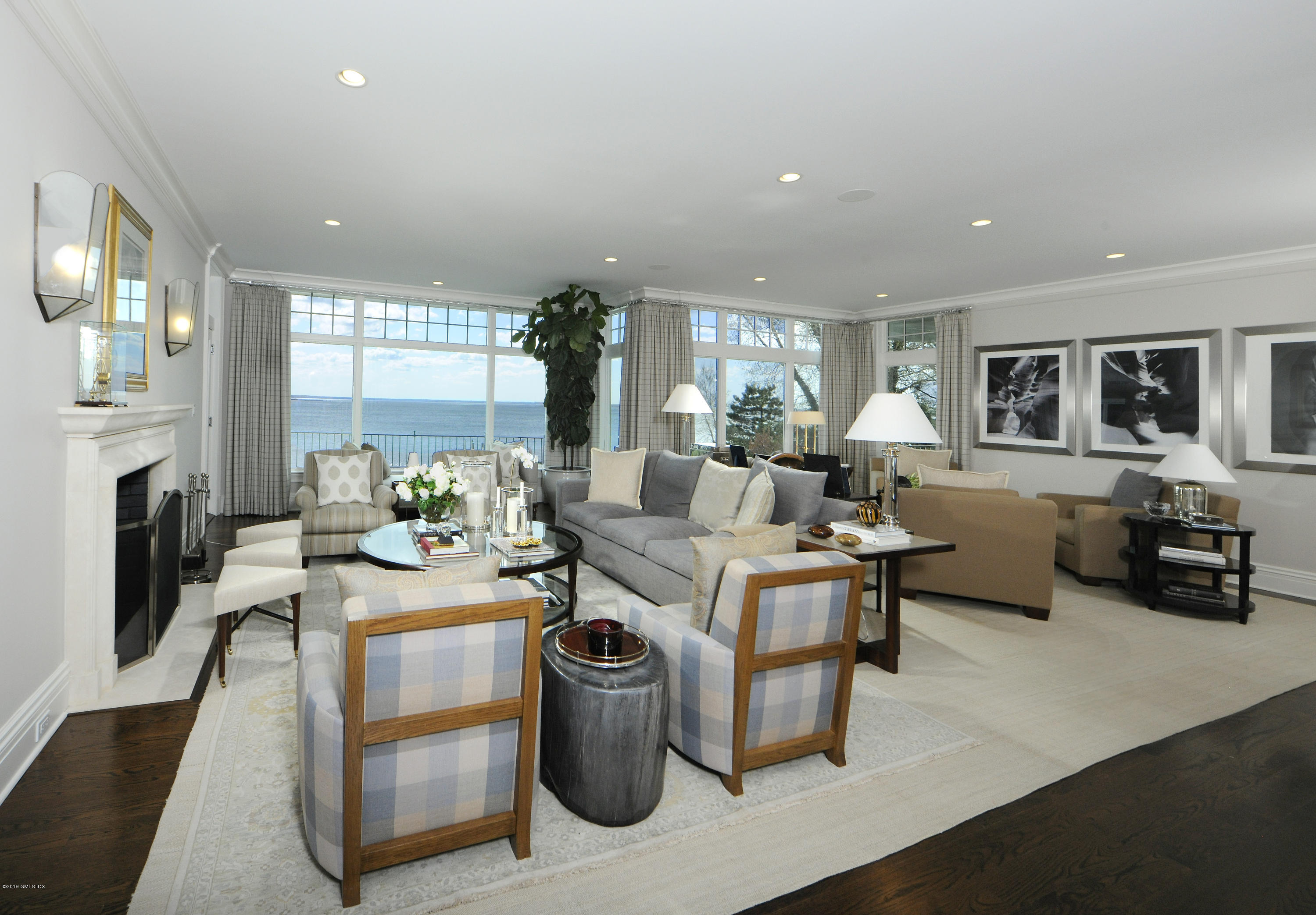 215 Byram Shore Road Greenwich, CT 06830 - Photo 5 of 26 a living room with fireplace furniture and a wooden floor