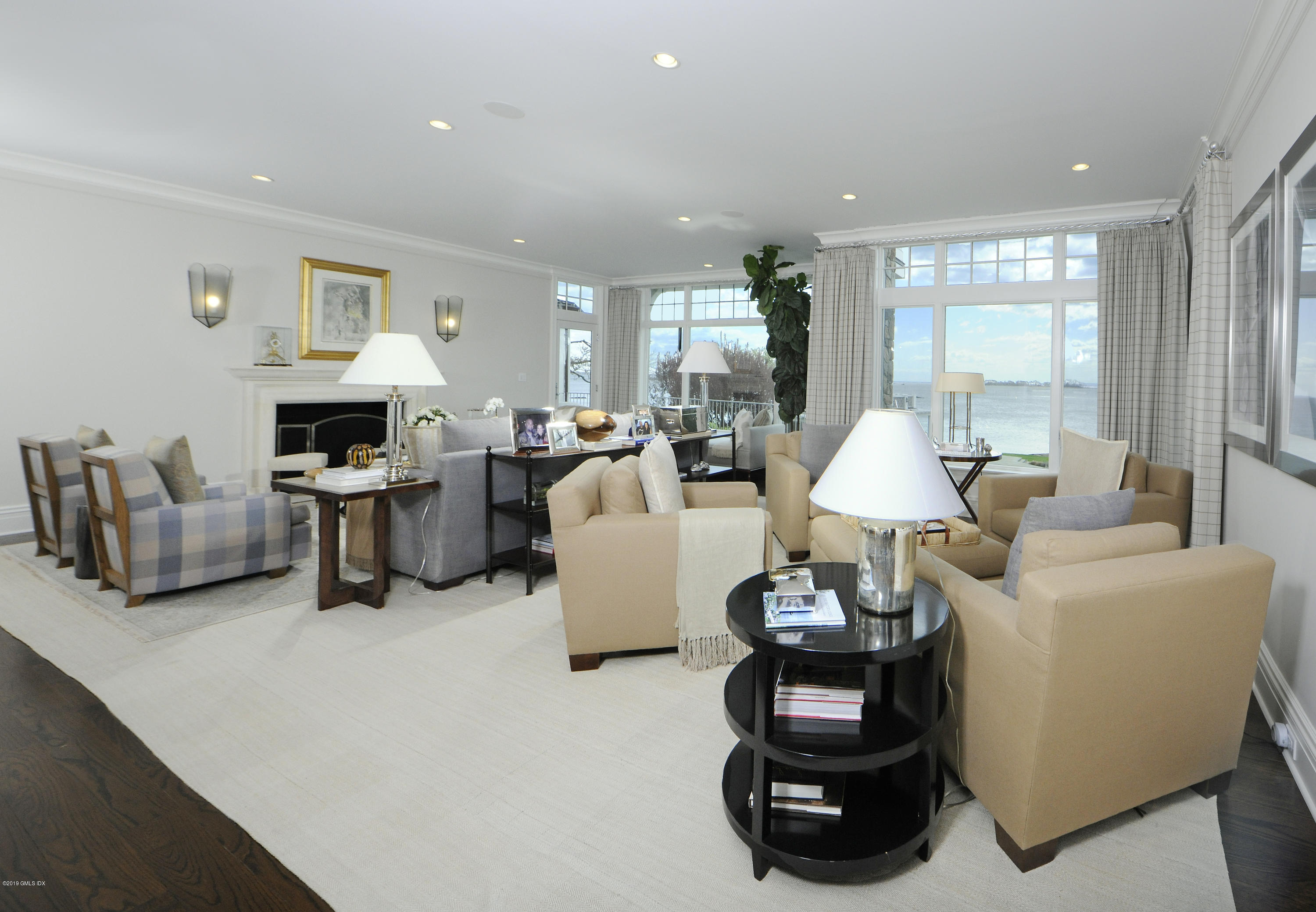 215 Byram Shore Road Greenwich, CT 06830 - Photo 6 of 26 a living room with furniture a fireplace and a window