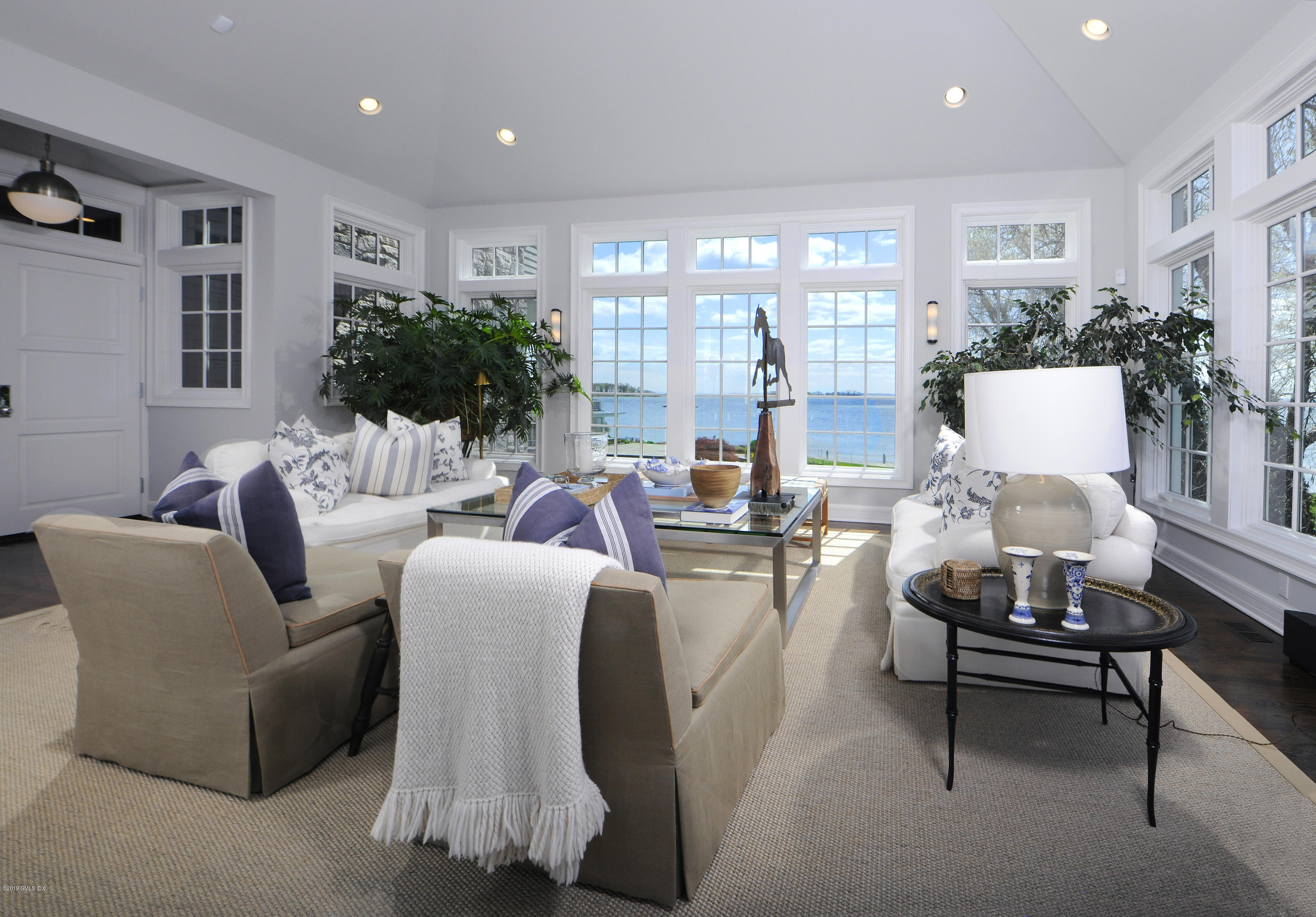 215 Byram Shore Road Greenwich, CT 06830 - Photo 9 of 26 a living room with furniture and a large window