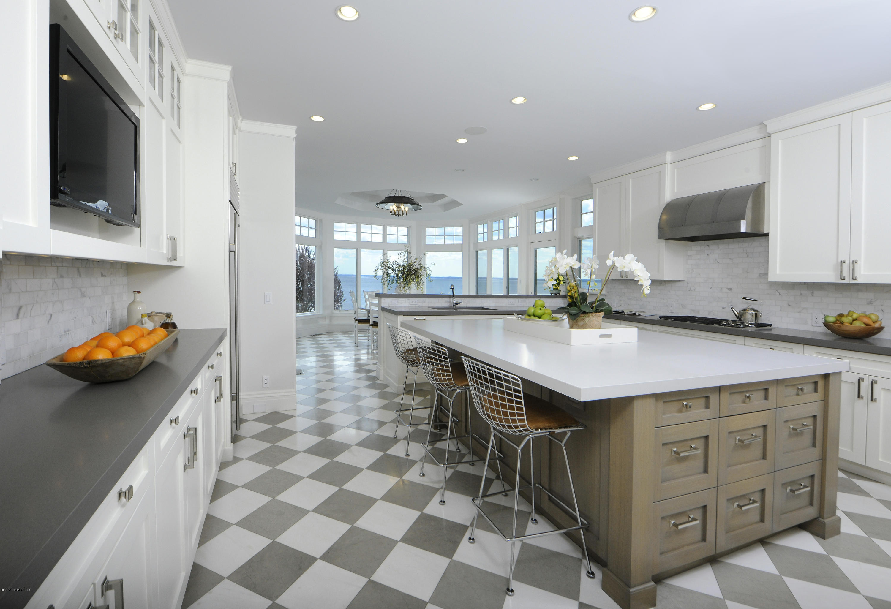 215 Byram Shore Road Greenwich, CT 06830 - Photo 10 of 26 a kitchen with a sink a counter top space and cabinets