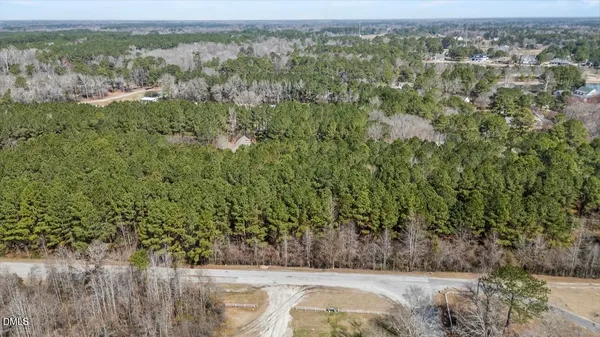 a view of a field with trees in the background
