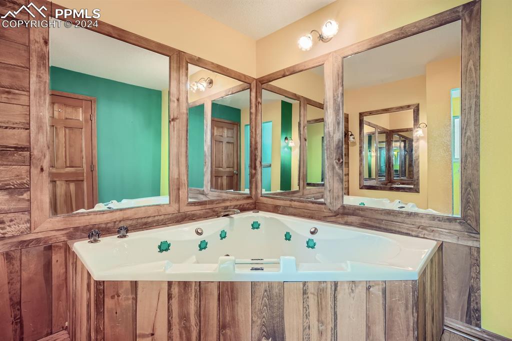 11330 Holmes Road Colorado Springs, CO 80908 - Photo 15 of 40 Bathroom with a tub to relax in
