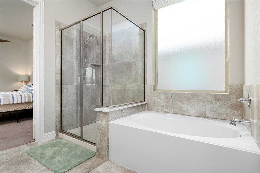 1320 Rosebush Road Aubrey, TX 76227 - Photo 20 of 33 a bathroom with a bathtub and a shower