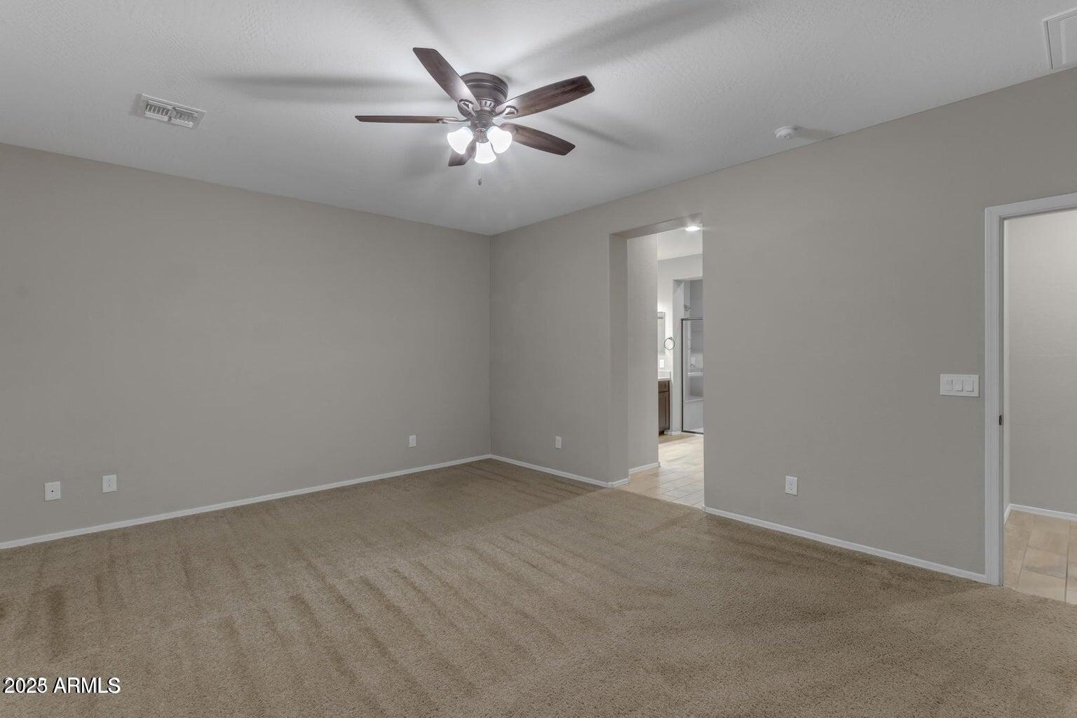 22841 South 225th Place Queen Creek, AZ 85142 - Photo 16 of 34 an empty room with chandelier fan and windows