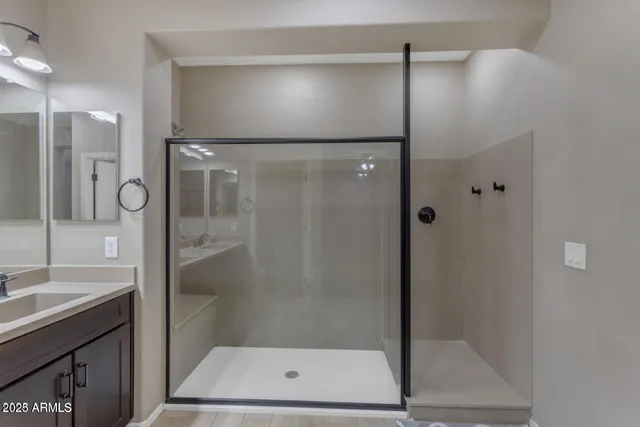 a bathroom with a shower and a sink