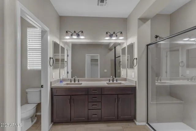 a bathroom with a double vanity sink mirror and double