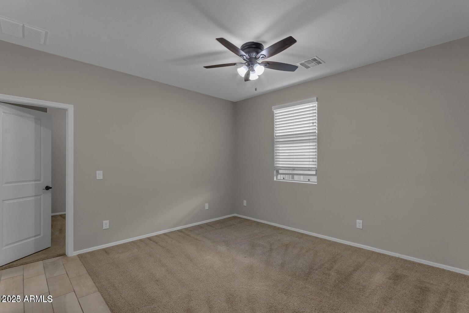 22841 South 225th Place Queen Creek, AZ 85142 - Photo 21 of 34 an empty room with windows and fan