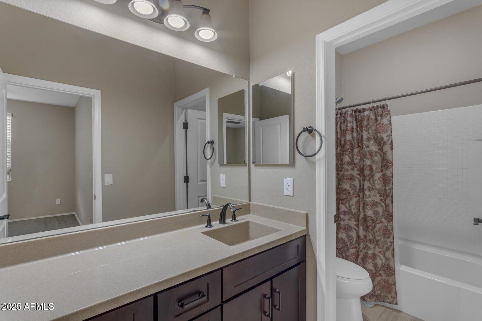 22841 South 225th Place Queen Creek, AZ 85142 - Photo 26 of 34 a bathroom with a sink a toilet a shower and a mirror