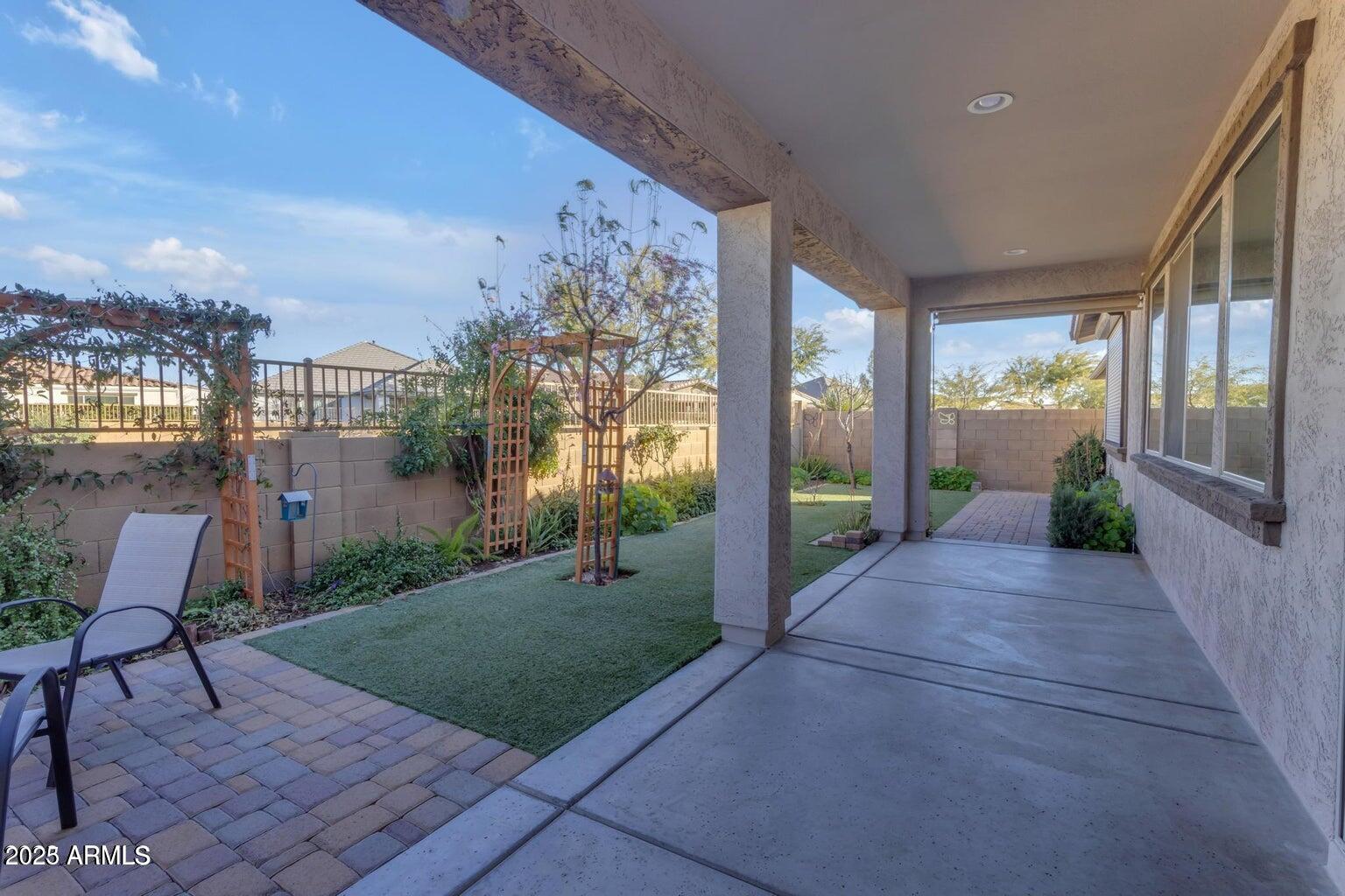22841 South 225th Place Queen Creek, AZ 85142 - Photo 30 of 34 a view of a porch with chairs and table next to a yard