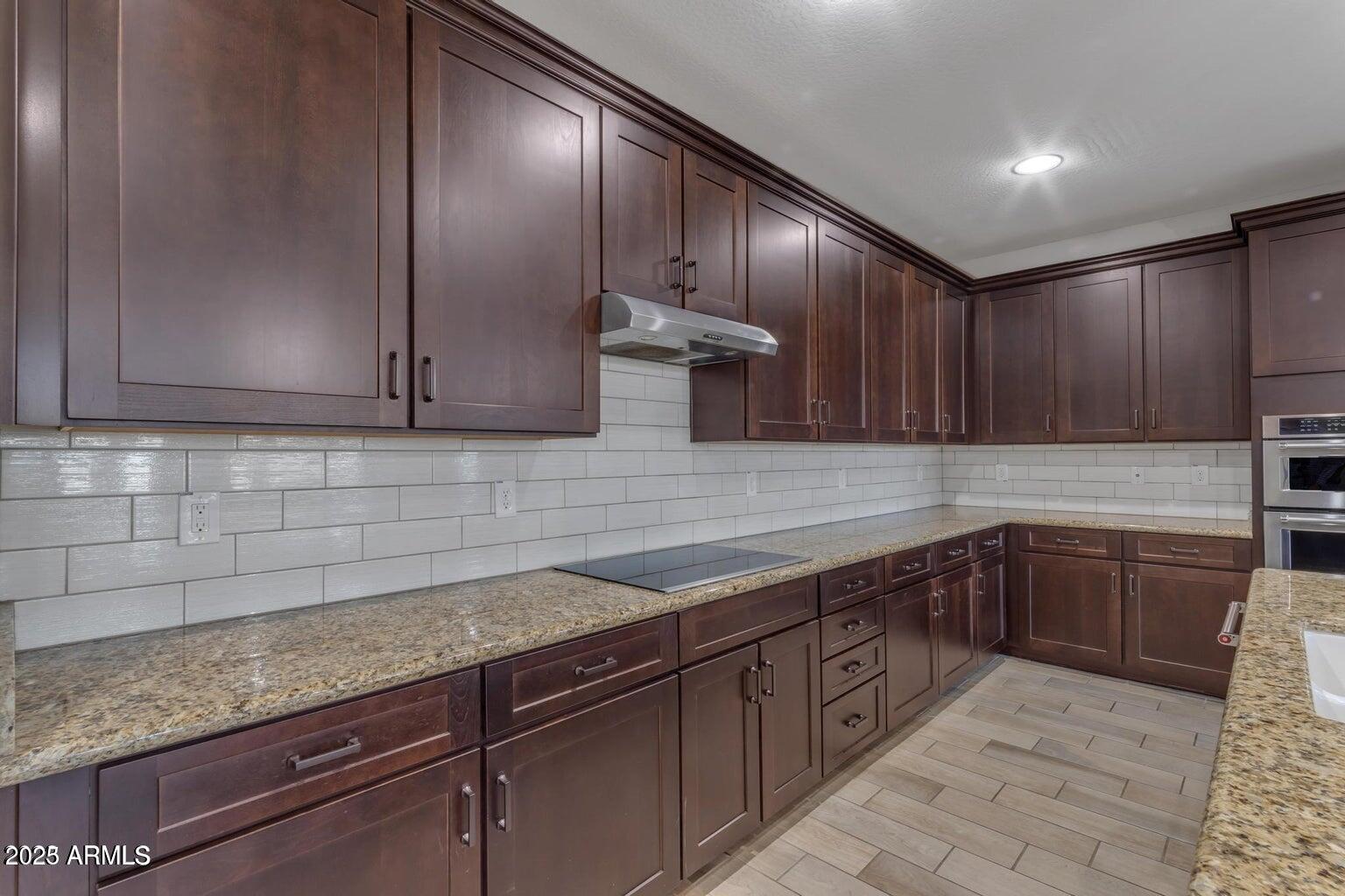 22841 South 225th Place Queen Creek, AZ 85142 - Photo 6 of 34 a kitchen with stainless steel appliances granite countertop a sink and cabinets