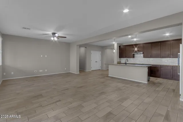 a view of a kitchen with a sink and cabinets