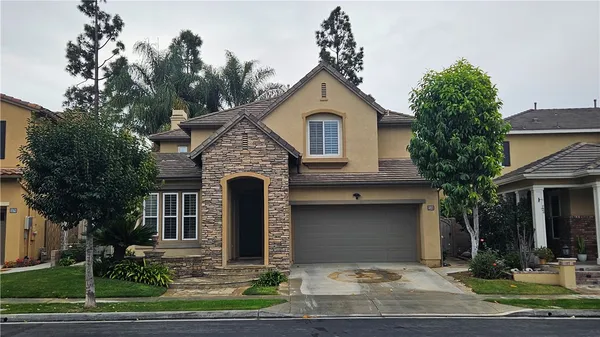 a front view of a house with garden
