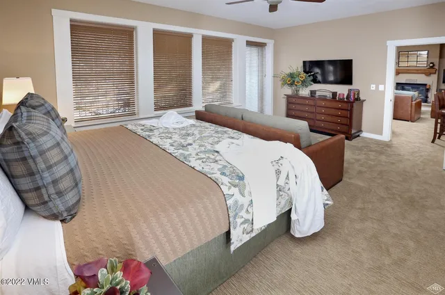 a bathroom with a granite countertop toilet sink and mirror
