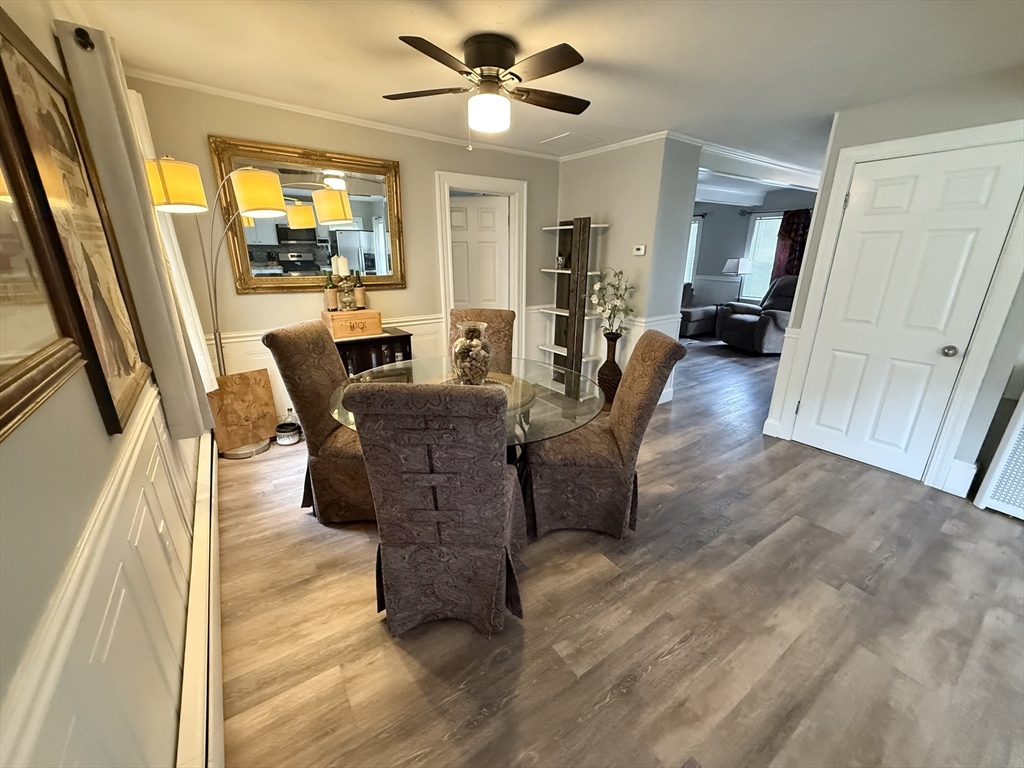 59 Brookfield Road Sturbridge, MA 01518 - Photo 18 of 40 a living room with couches a flat tv screen a dining table and chairs with wooden floor