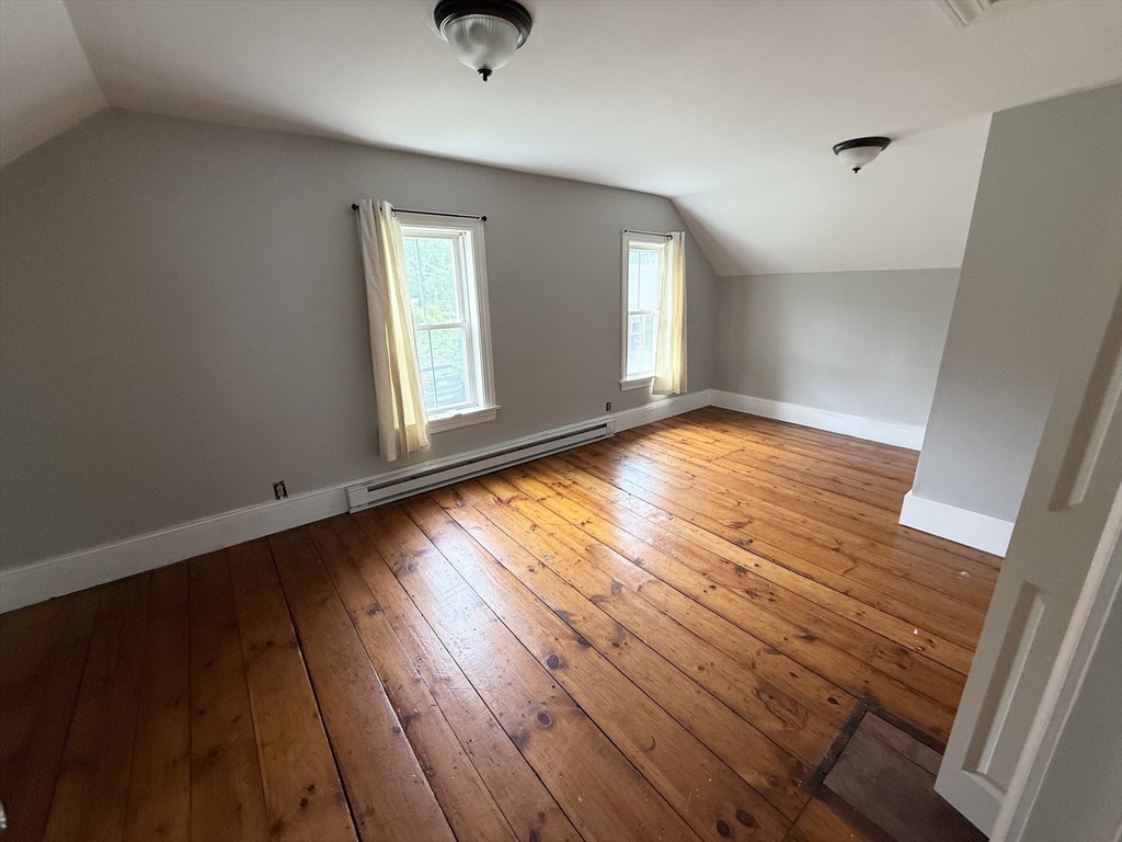 59 Brookfield Road Sturbridge, MA 01518 - Photo 33 of 40 a view of an empty room with wooden floor and a window