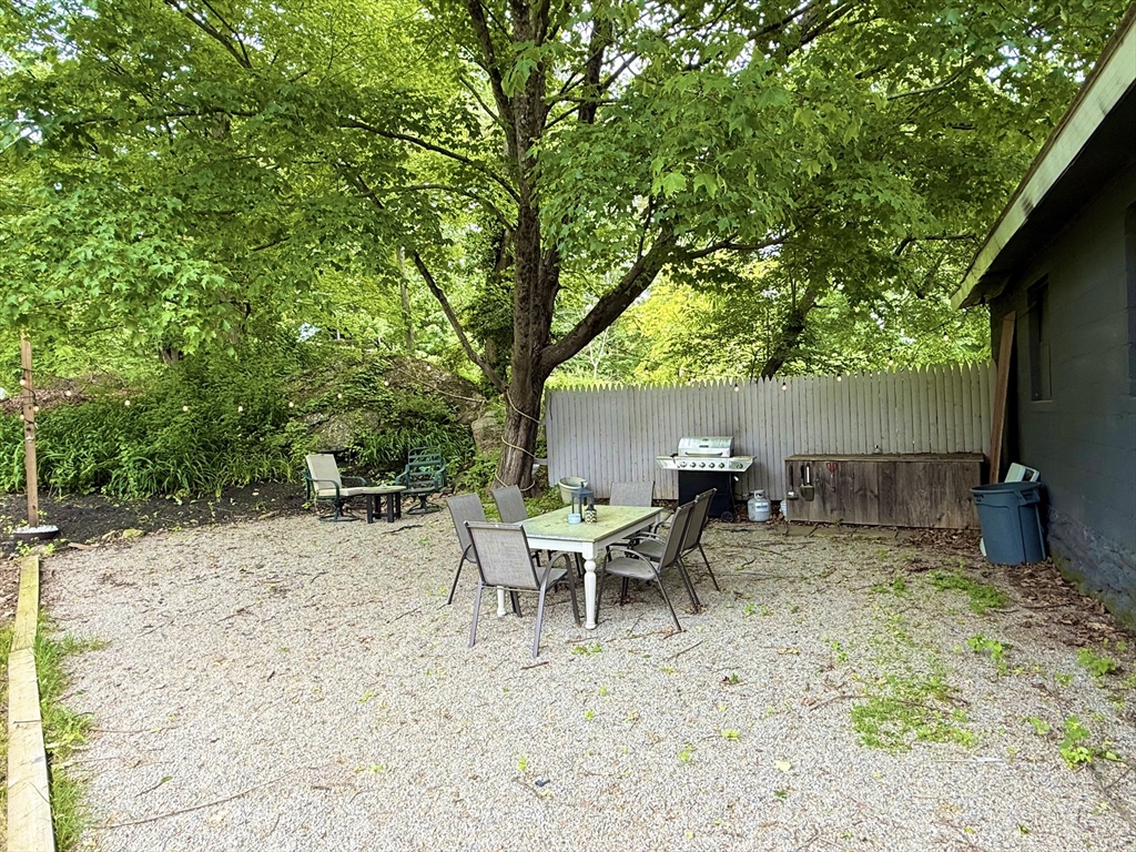 59 Brookfield Road Sturbridge, MA 01518 - Photo 37 of 40 a view of a backyard with furniture and a tree