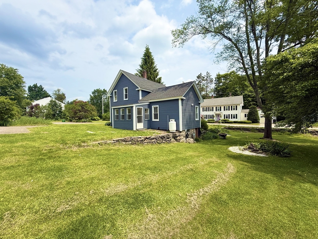 59 Brookfield Road Sturbridge, MA 01518 - Photo 8 of 40 a front view of a house with garden and trees